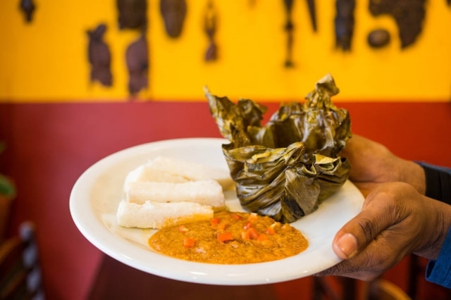 Cameroonian koki: black-eyed bean cake cooked on banana leaf in palm oil and served with a mixture of sauteed peas and cooked potatoes. 
