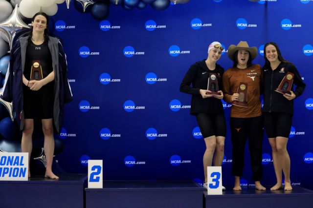 Transgender swimmer Leah Thomas of the University of Pennsylvania poses on the podium after winning the 500-yard freestyle, while medalists Emma Wyant, Erica Sullivan and Brock Fordy pose for a photo at the NCAA Division I women's swimming and diving championships on March 17, 2022 in Atlanta, Georgia.