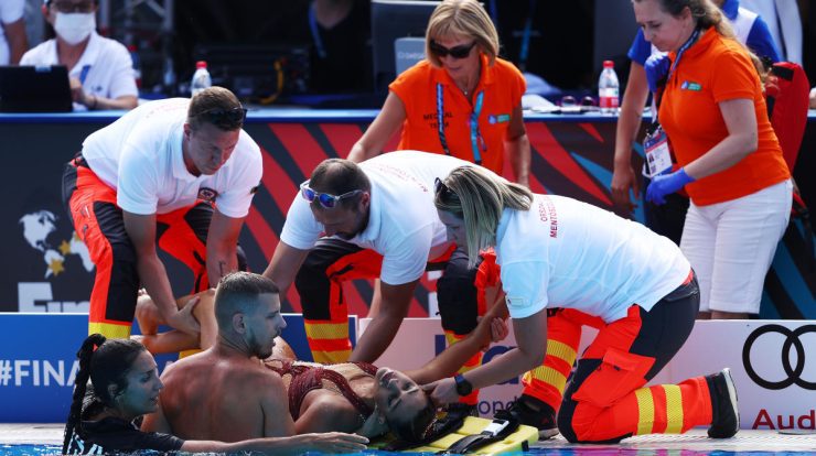 A professional swimming athlete removed from a stretcher in the pool in the world